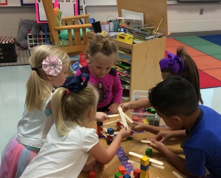 children playing with sticks and blocks 